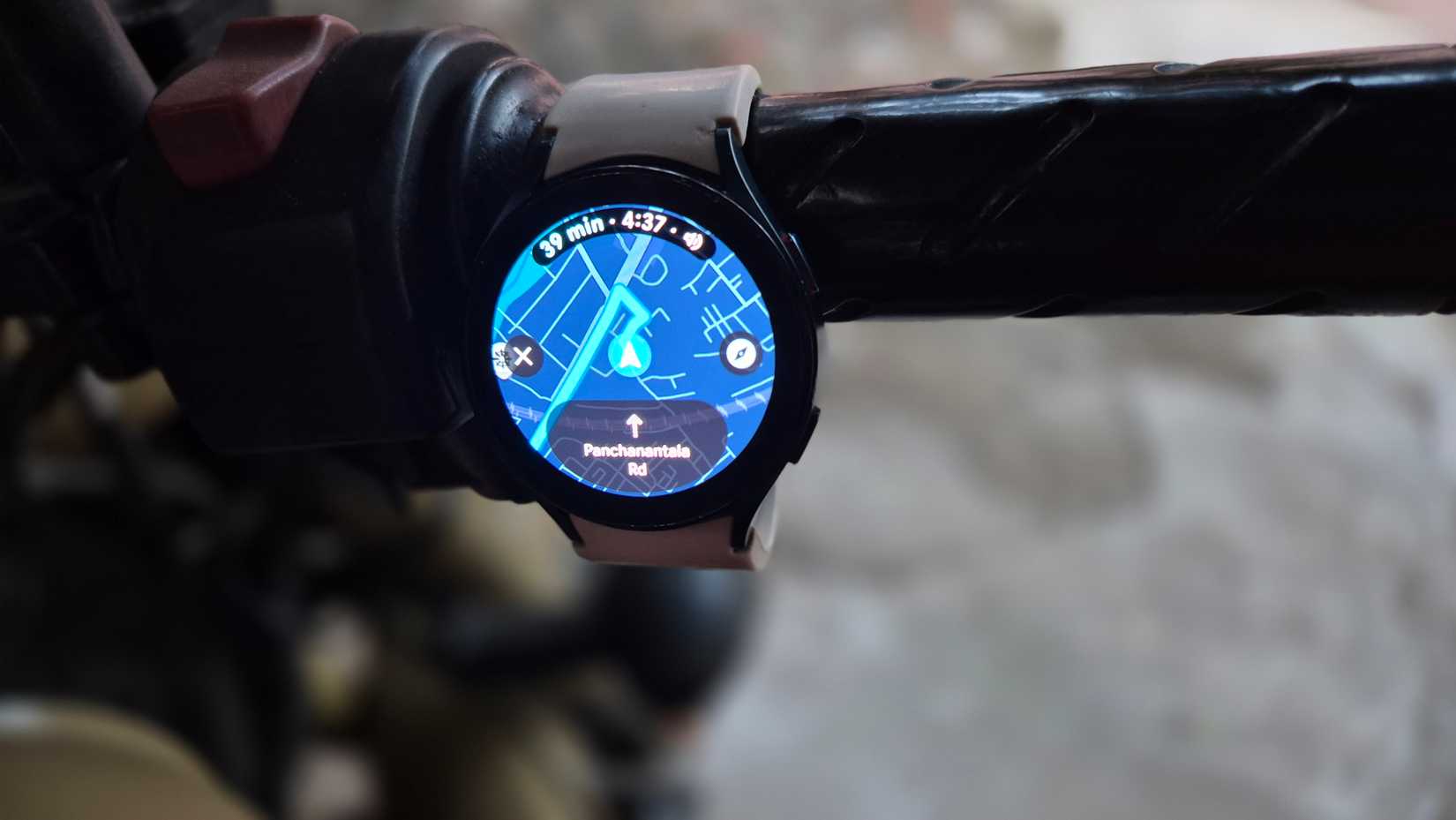 The Samsung Galaxy Watch 4 strapped to a bike handle.