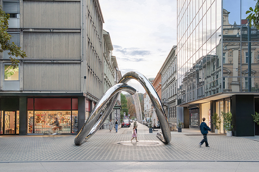 continuous steel loop forms water sculpture reflecting ljubljana’s urban fabric