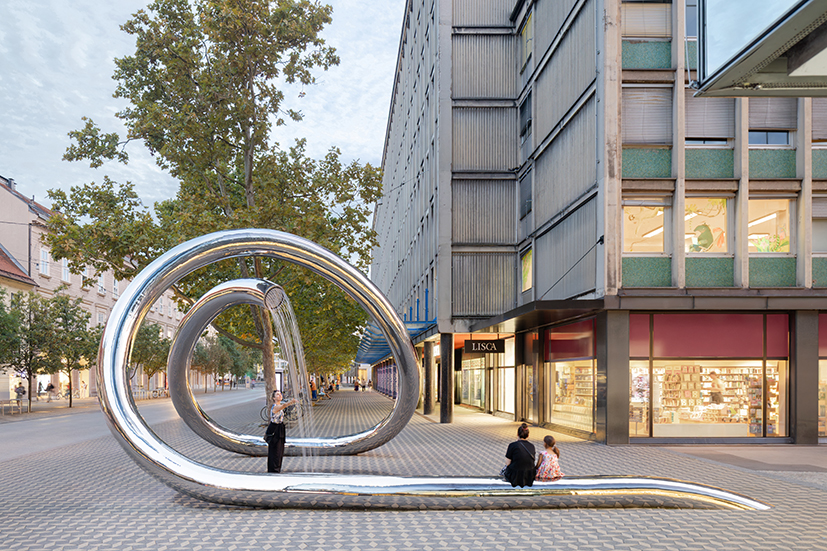 continuous steel loop forms water sculpture reflecting ljubljana’s urban fabric