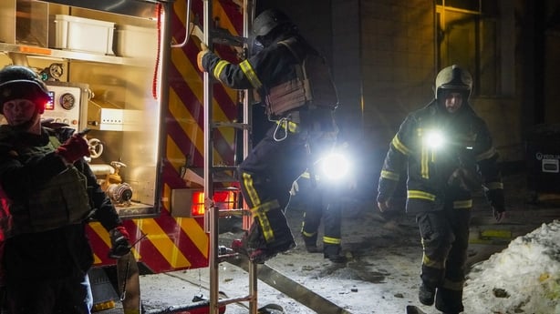 Ukrainian emergency workers are seen at the site of an apartment building that was damaged following a Russian air attack in Kyiv early on February 3, 2026