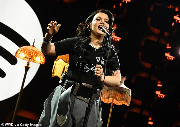 For the performance, Lola donned a black VAQUERA crown top, teamed with stylish grey wide-leg trousers