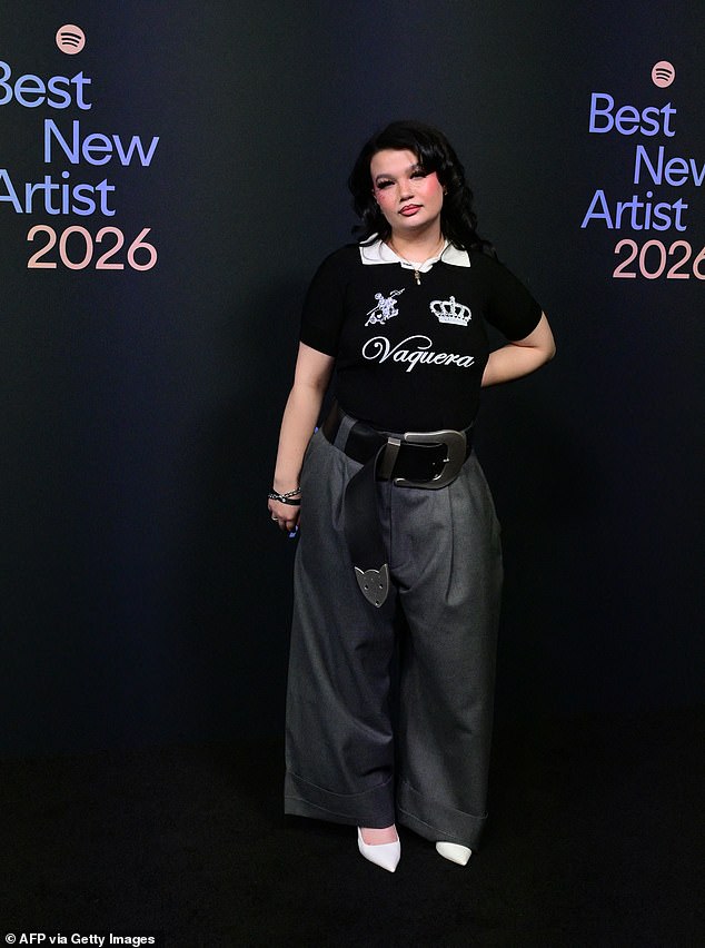 She added inches to her frame with pointed white heels and completed the look with an oversized black belt