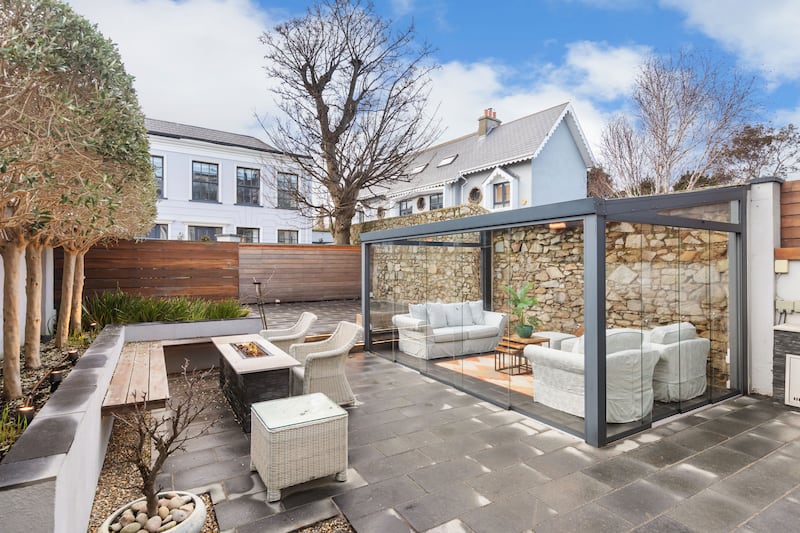 Low-maintenance rear garden with fully glazed sunroom