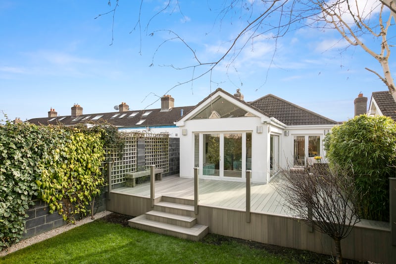 The rear garden has a large composite deck overlooking a lawn
