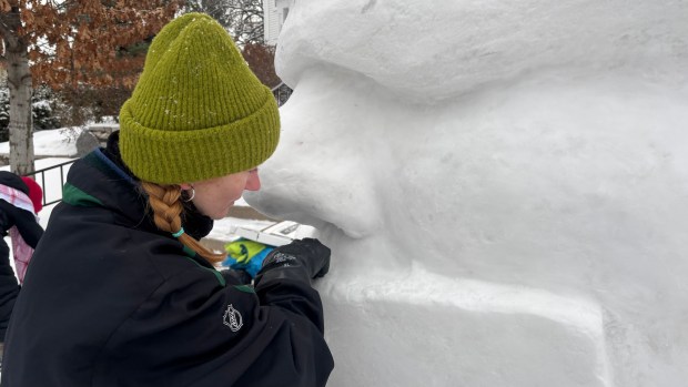 Snow sculptor Siera Himmerich works on a large face, a portion of a collaborative sculpture speaking out about ICE activity, on Feb. 1, 2026, near Lake of the Isles in Minneapolis. Himmerich is a member of a sculpting team whose "ICE OUT MN" work was controversially disqualified and defaced at the Vulcan Snow Park in January. (Jared Kaufman / Pioneer Press)