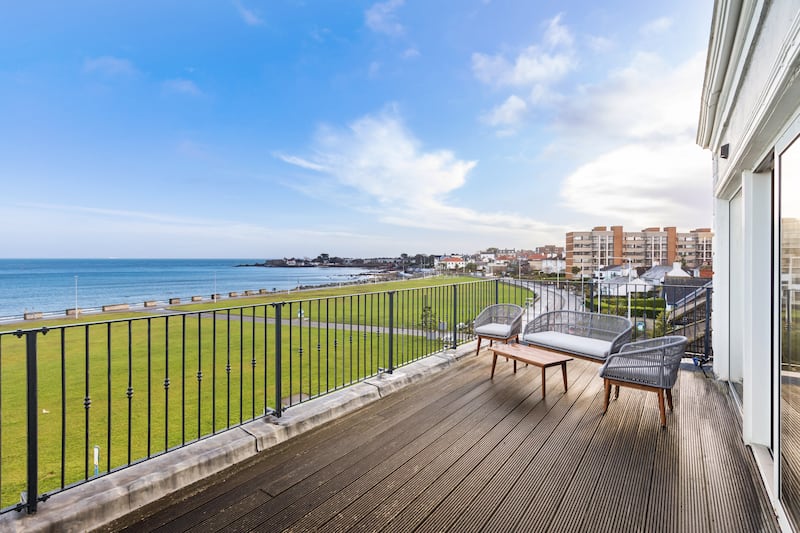 The balcony runs the full width of the house