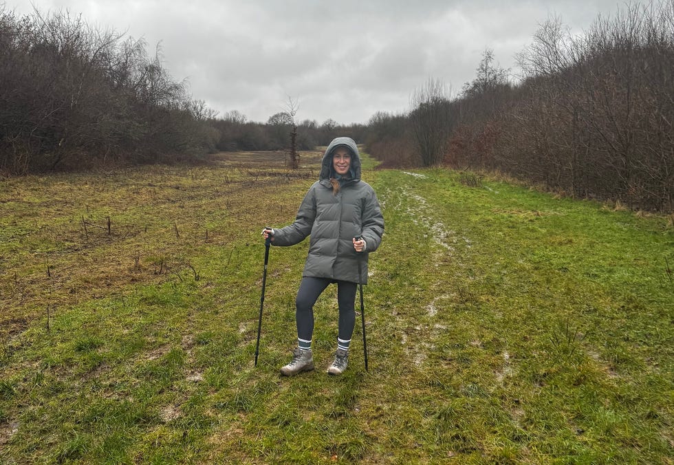 hiker on a muddy pathway in a cloudy outdoor setting