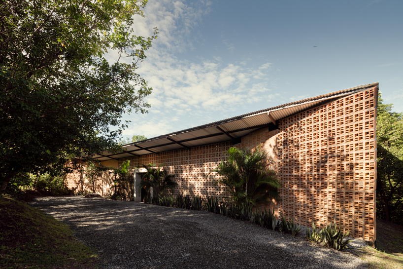 a series of porous brick partitions enclose central garden within costa rica residence