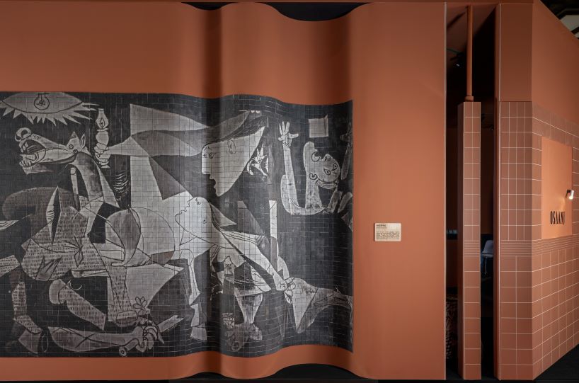 patterned tiles extend from curved walls to furniture in layered retail exhibition booth