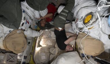 NASA astronauts Chris Williams and Zena Cardman, both Expedition 74 Flight Engineers, work on spacesuit maintenance inside the International Space Station's Quest airlock.