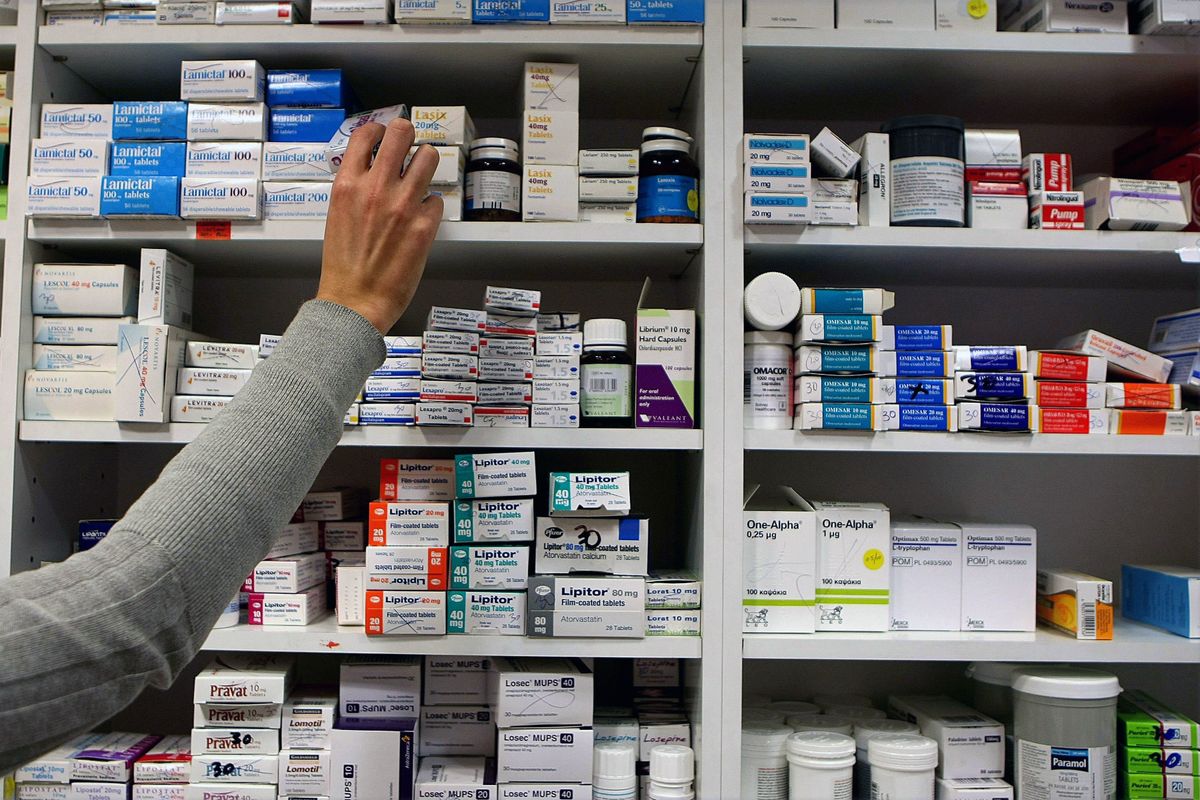 a pharmacist stocking shelves