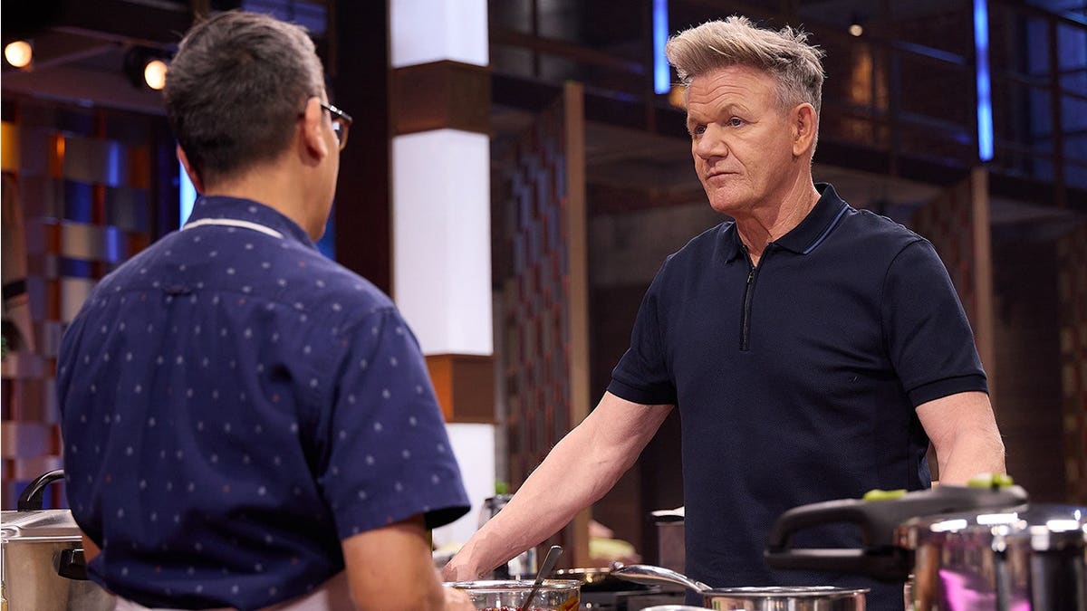 Gordon Ramsay standing beside auditioner Foo on the MASTERCHEF