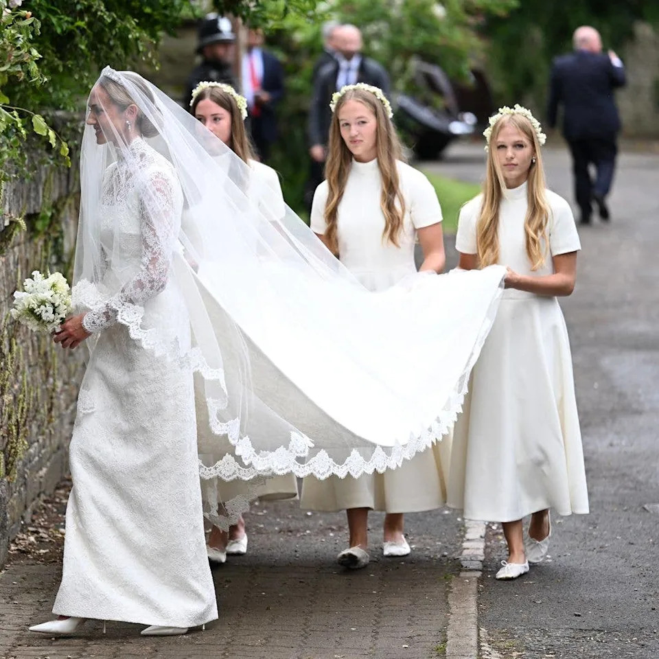 Harriet Sperling arrives for her wedding to Peter Phillips followed by her bridesmaids Georgina Sperling, Savannah Phillips and Isla Phillips at All Saints Church