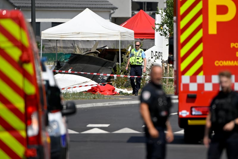 Rescuers and security personnel work alongside the wreckage of a Pilatus PC-6 light aircraft after it crashed. Photograph: Jean-Christophe Verhaegen/AFP via Getty Images