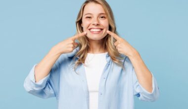 Young Happy Woman Pointing at Smile Teeth