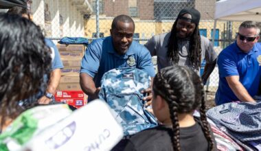 Marcelle Gibson, of North Philadelphia, business agent for TWU Local 234, meets Josyah Pratts, 9, a third grade student, during the Transport Workers Union Local 234 school supply giveaway at Alexander McClure Elementary.