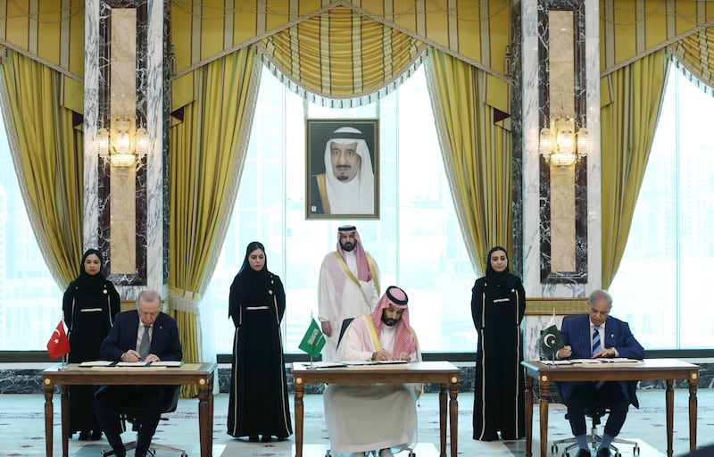 Turkish president Recep Tayyip Erdogan, Saudi crown prince Mohammed bin Salman and Pakistani prime minister Shehbaz Sharif sign a trilateral defense agreement in Mecca, Saudi Arabia. Photograph: Turkish Presidency/Getty