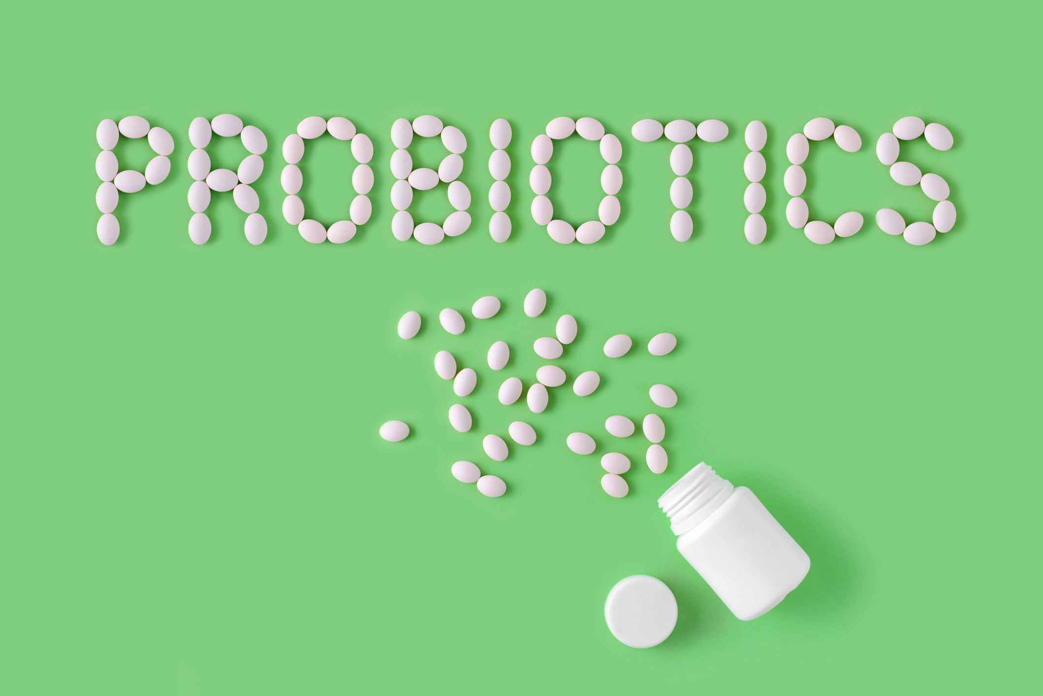 Probiotics word made of pills on green background