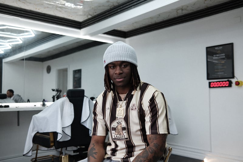 Reggie at Relief Barber shop, Dundalk, wearing his 'Risky Business' medallion. Photograph: Conor Capplis