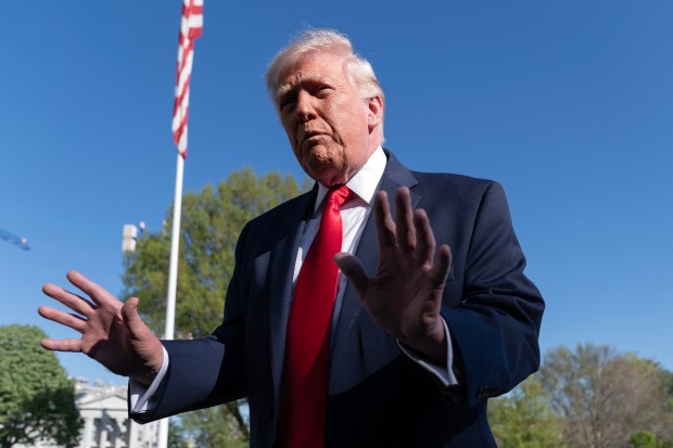 President Donald Trump talks to the media on the South Lawn before departing on Marine One at the White House, Saturday in Washington. (AP Photo/Jose Luis Magana)