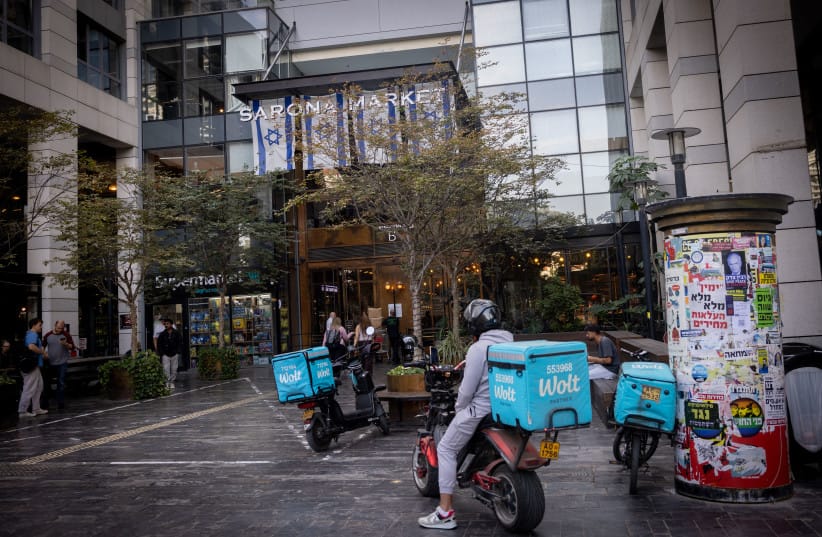 WOLT delivery people outside Sarona market in Tel Aviv, November 18, 2025.