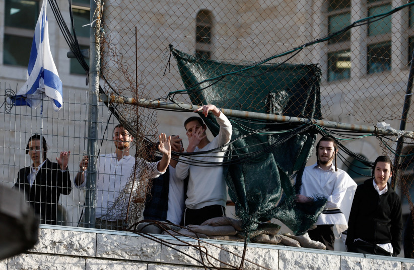 Israeli settlers gesture during a weekly settlers' tour in Hebron, in the West Bank, February 7, 2026.