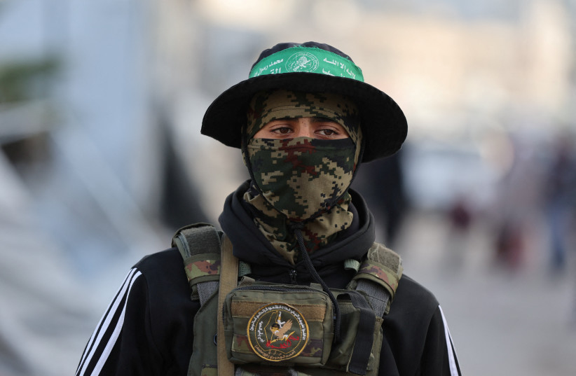 A HAMAS terrorist stands on a street during Eid al-Fitr in Gaza City.