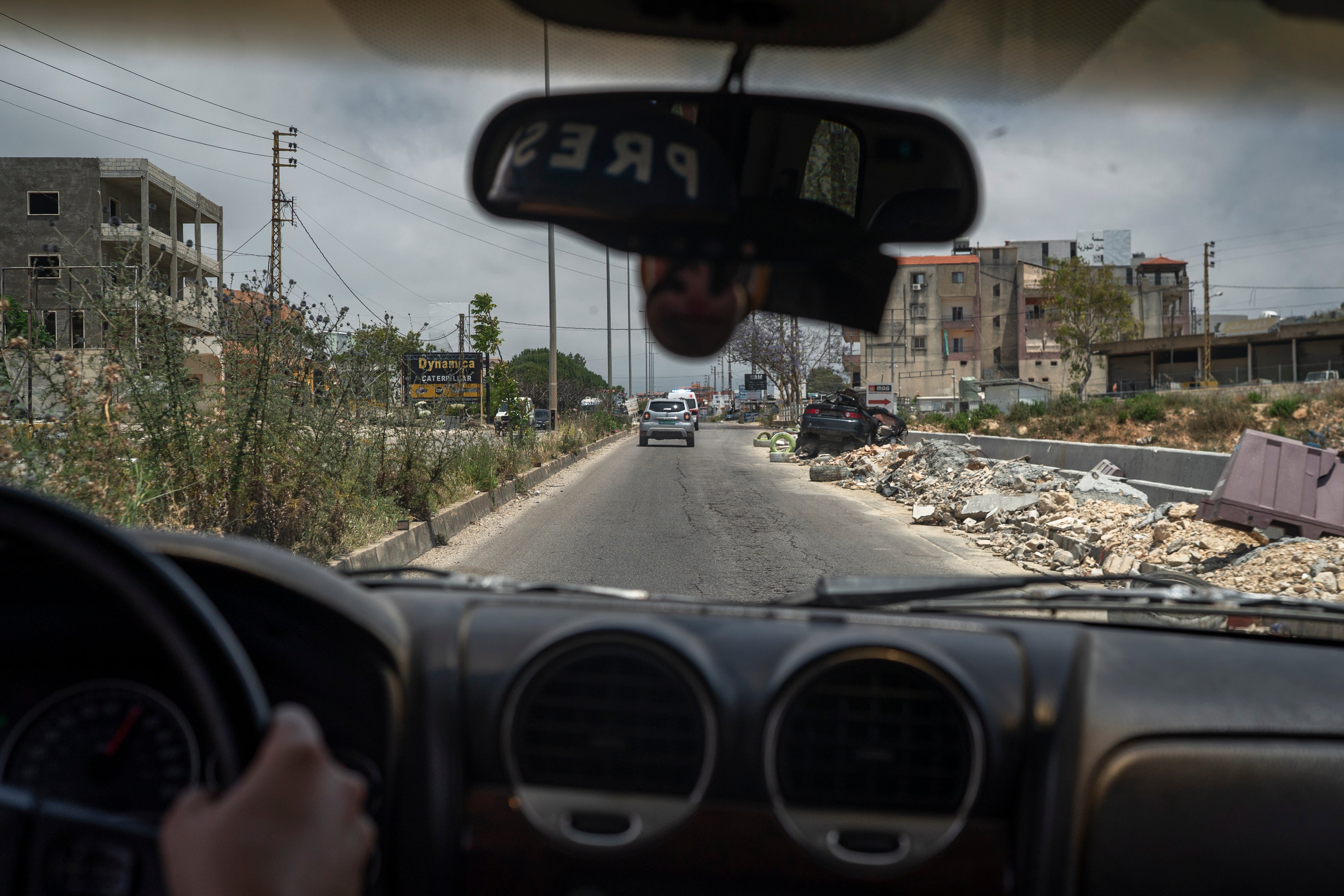 A car destroyed on the road, seen from inside another vehicle, on June 2, 2026 in Nabatieh, Lebanon