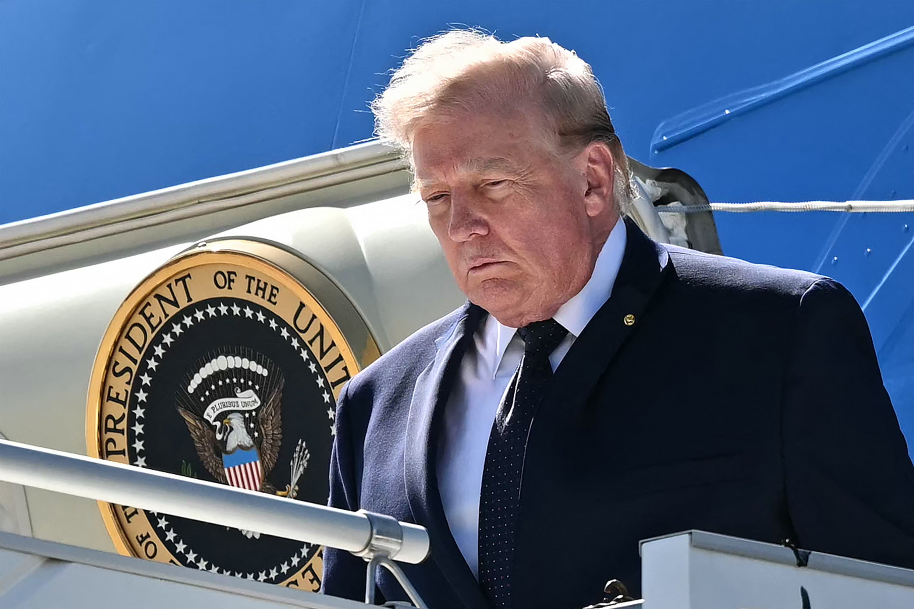 Donald Trump disembarks Air force One after landing at the Geneva airport ahead of the G7 summit, in Geneva on June 15