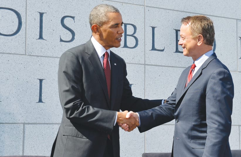 Shaking hands with then-US President Barack Obama at the dedication of the American Veterans Disabled for Life Memorial, in Washington, 2014.