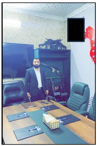 Al-Saadi standing in front of an array of machine guns in a picture taken on or around February 12, 2024, according to the indictment (US Justice Department)