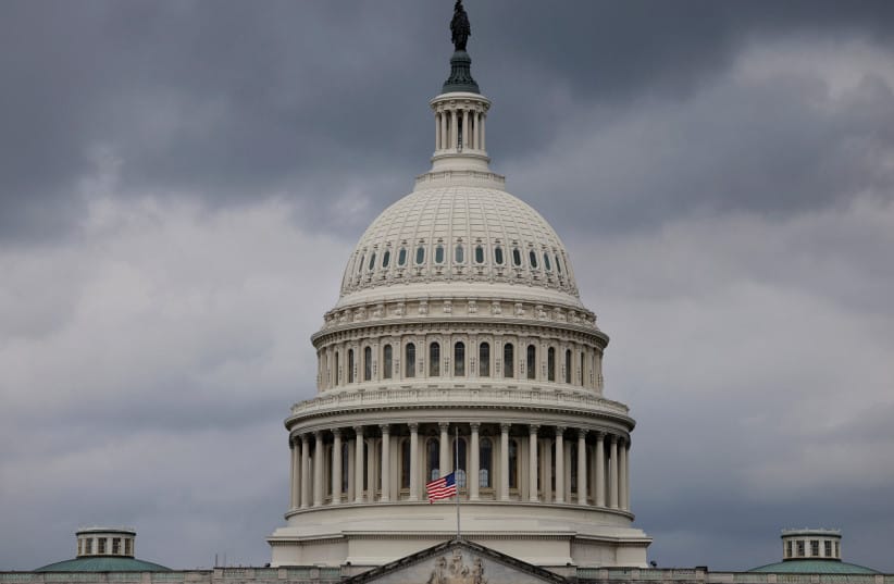 The U.S. flag flies at half staff outside of the US Capitol building.