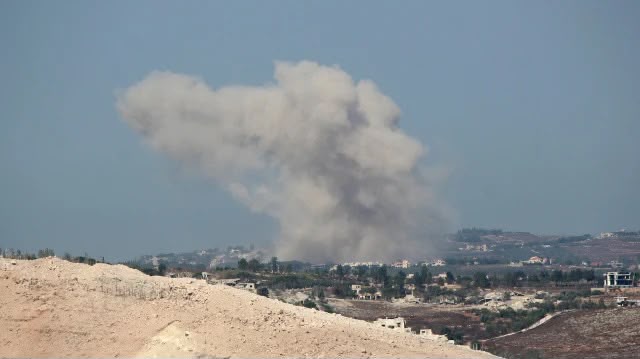 A distant view of smoke rising after explosions in Hadatha by Israeli army (Photo: Anadolu Agency)