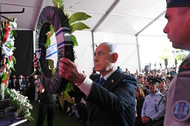 Israel's Prime Minister Benjamin Netanyahu lays a wreath during a state memorial ceremony.
