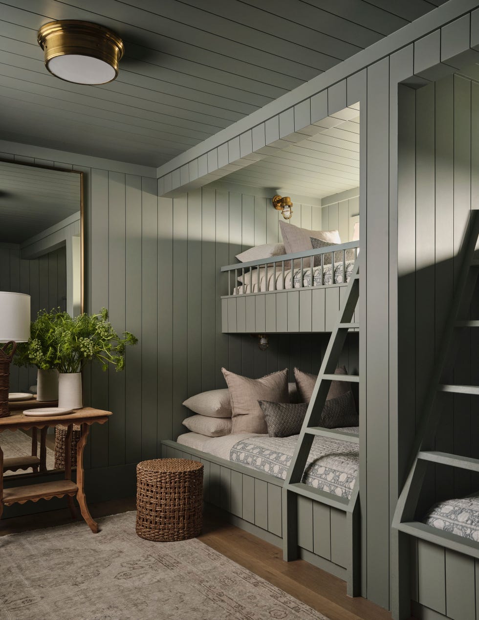 cozy bedroom with builtin bunk beds and a sitting area