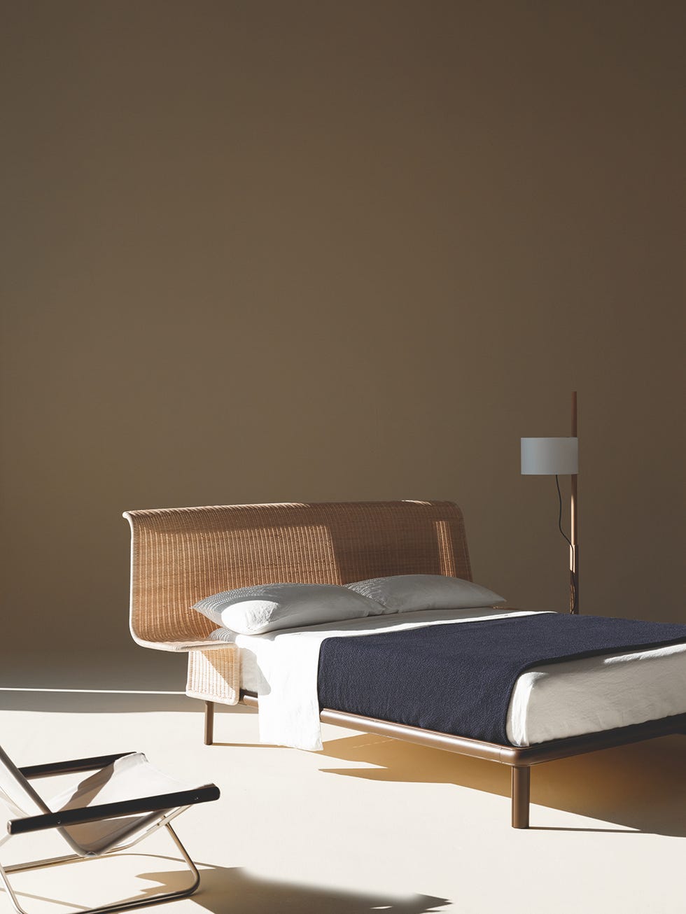modern bedroom setup with a woven bed and minimalistic design