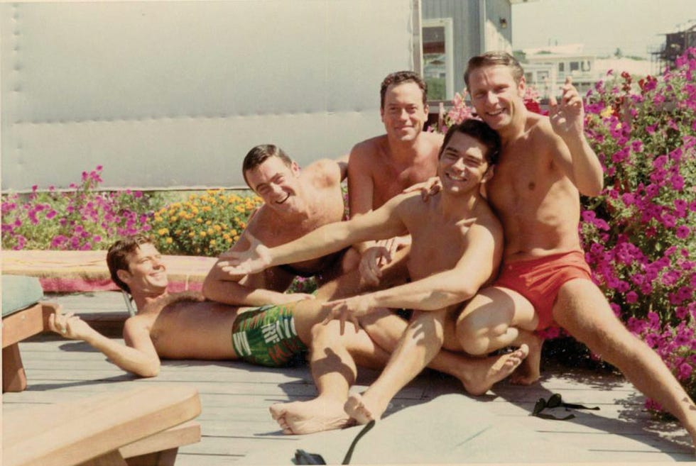 group of men lounging outdoors in casual summer attire