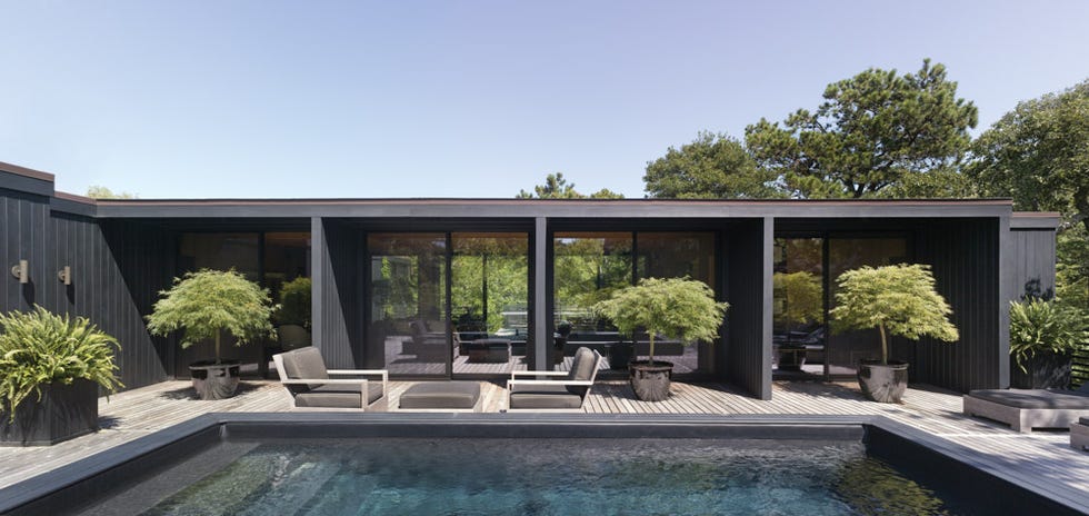 modern black exterior house with a pool and patio area