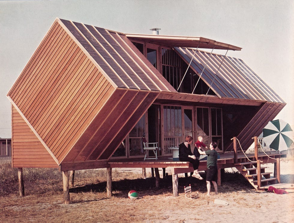 unique architectural design of a beach house with a family enjoying the setting