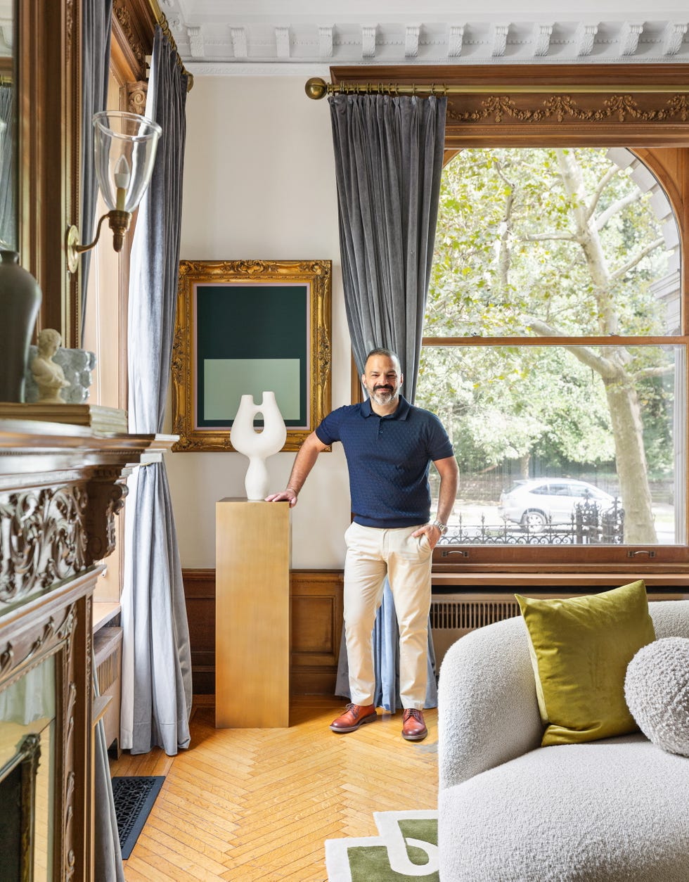 A stylish interior featuring a sculpture decorative curtains and a modern armchair