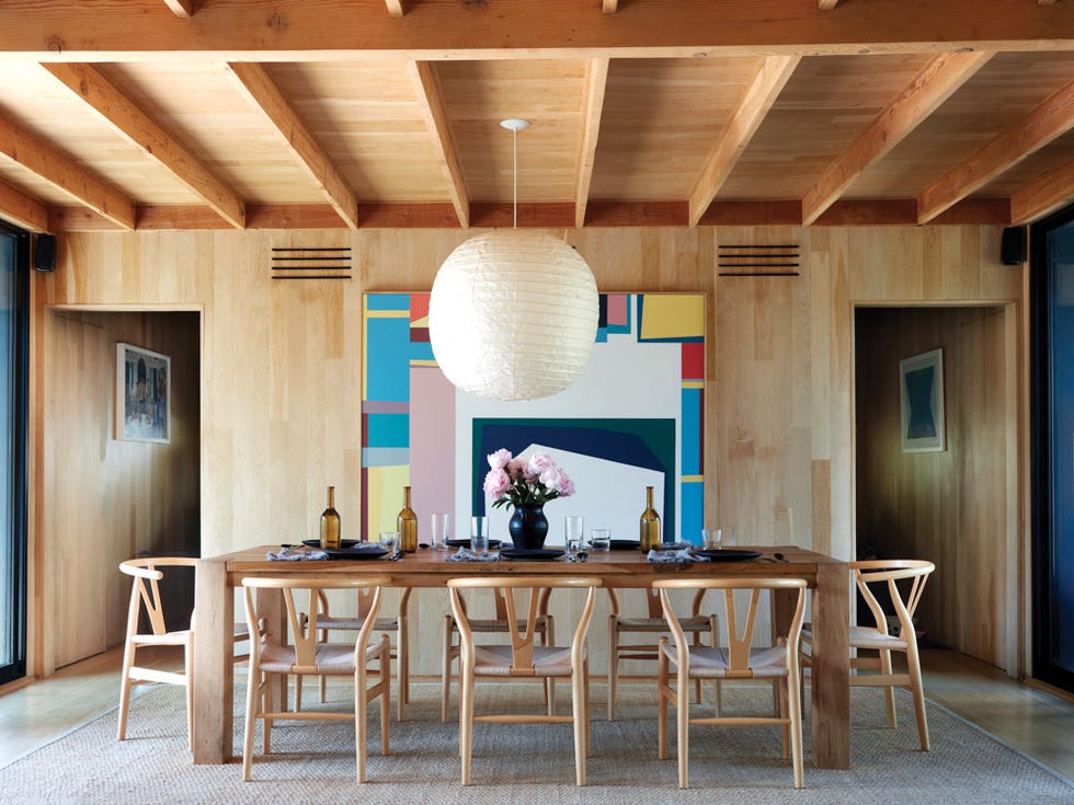 dining room with a wooden table chairs and modern art
