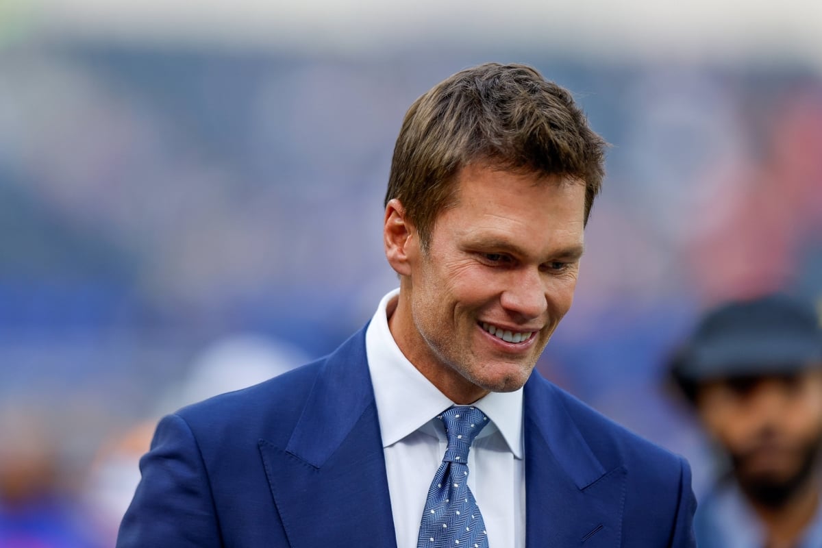 Tom Brady talks to fans before an NFL game