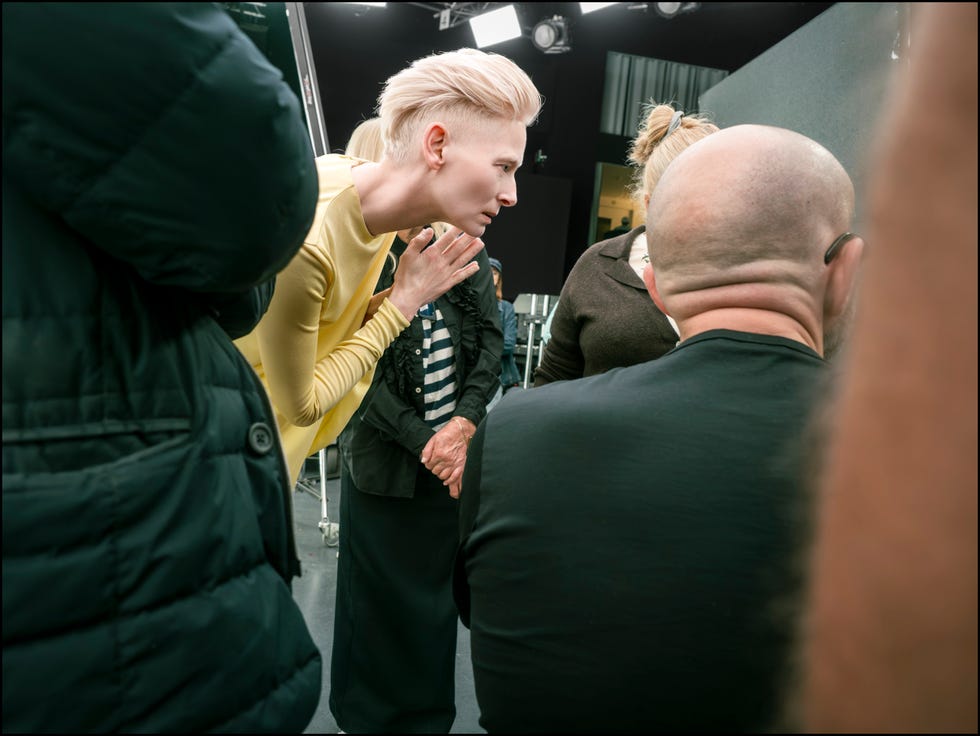 group of people engaged in conversation in a studio setting