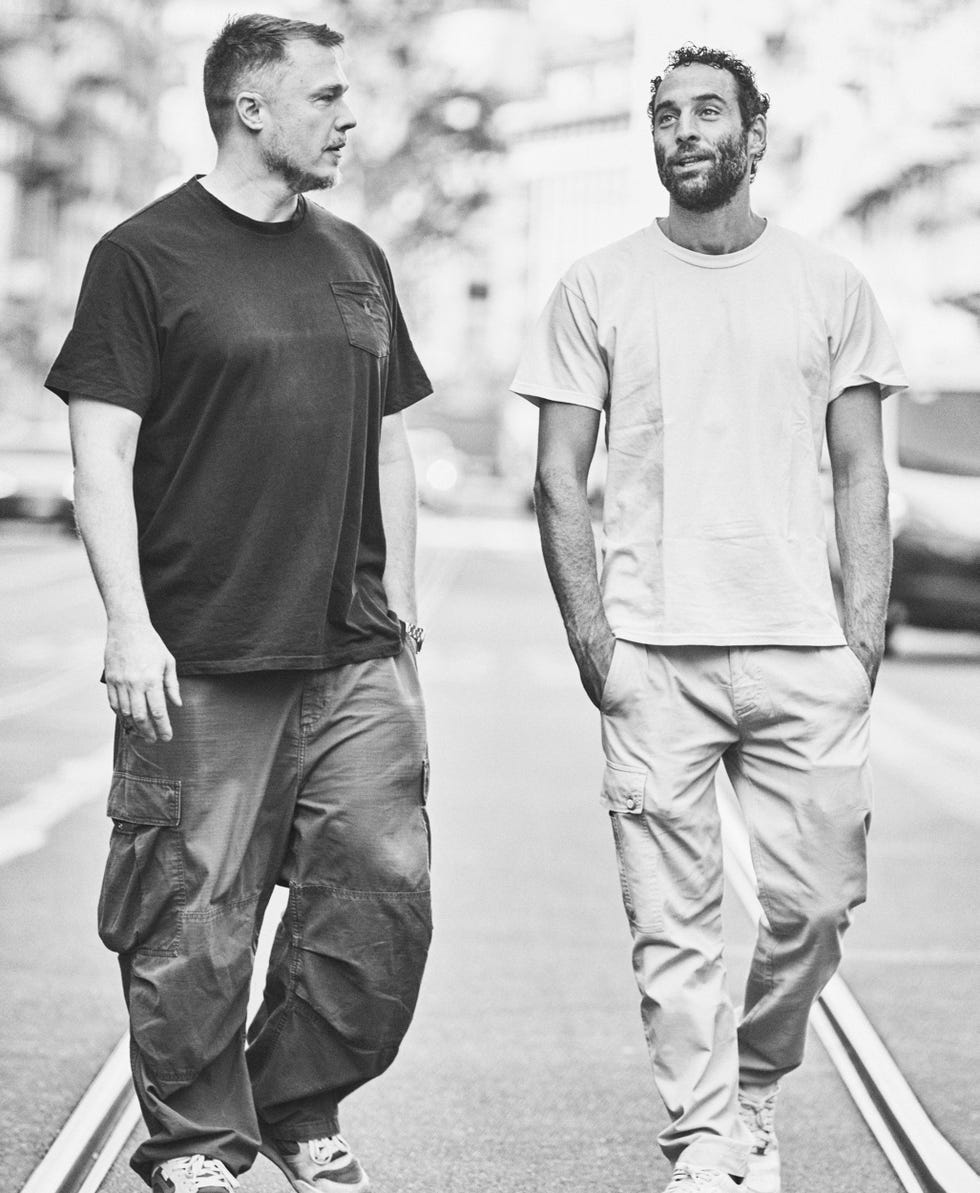 two men walking on a city street