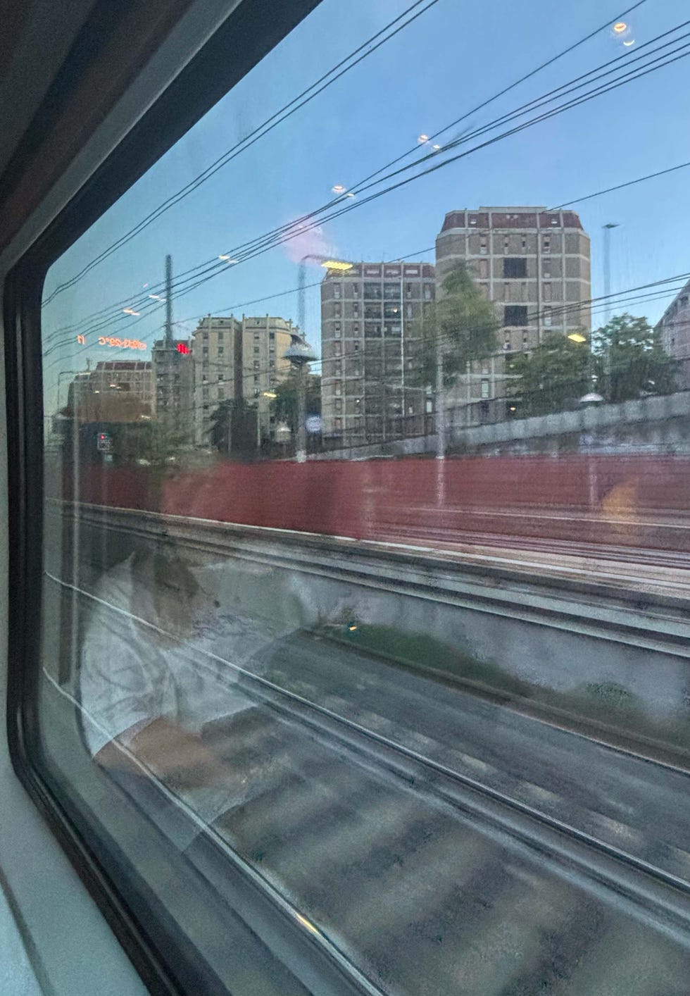 urban scenery viewed from a train window at dusk