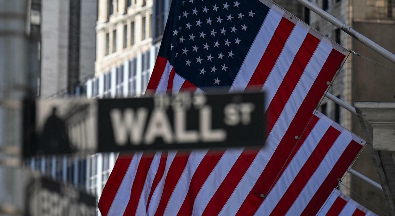 An American flag flies near the New York Stock Exchange (NYSE) in the Financial District in New York City on April 8, 2025. Wall Street stocks surged higher early Tuesday as global markets rallied following deep losses in hopes of trade agreements...