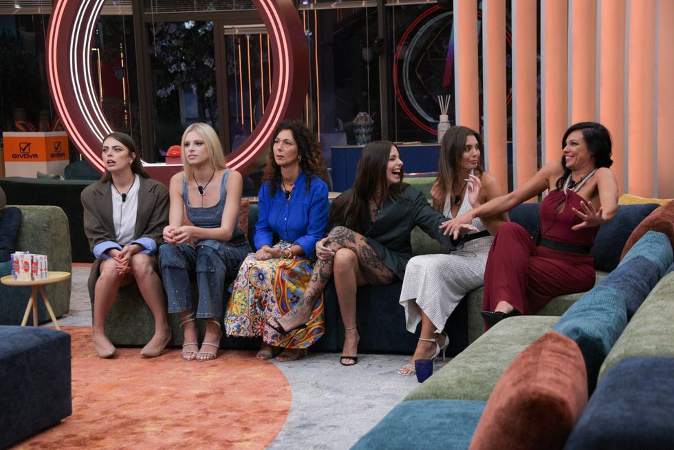 group of people seated on a couch in a modern interior setting