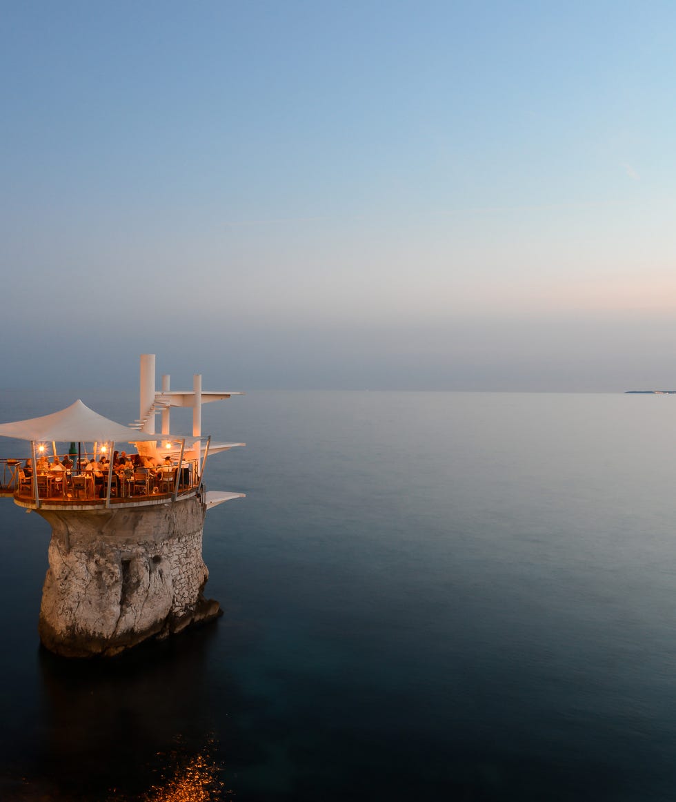 restaurant on a rocky outcrop overlooking the sea at twilight