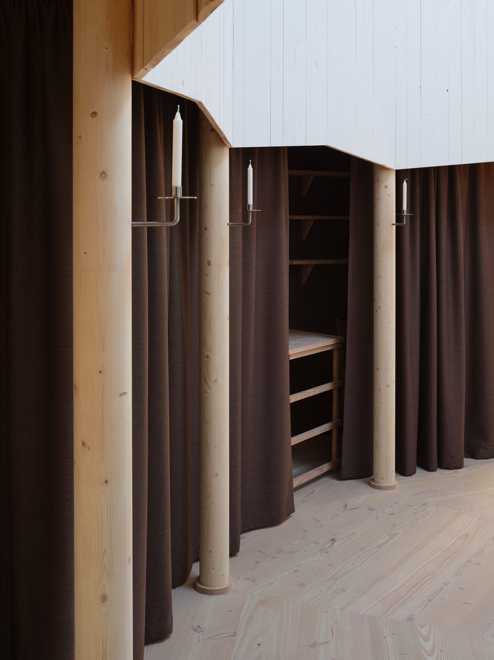 interior space featuring wooden structures and dark curtains