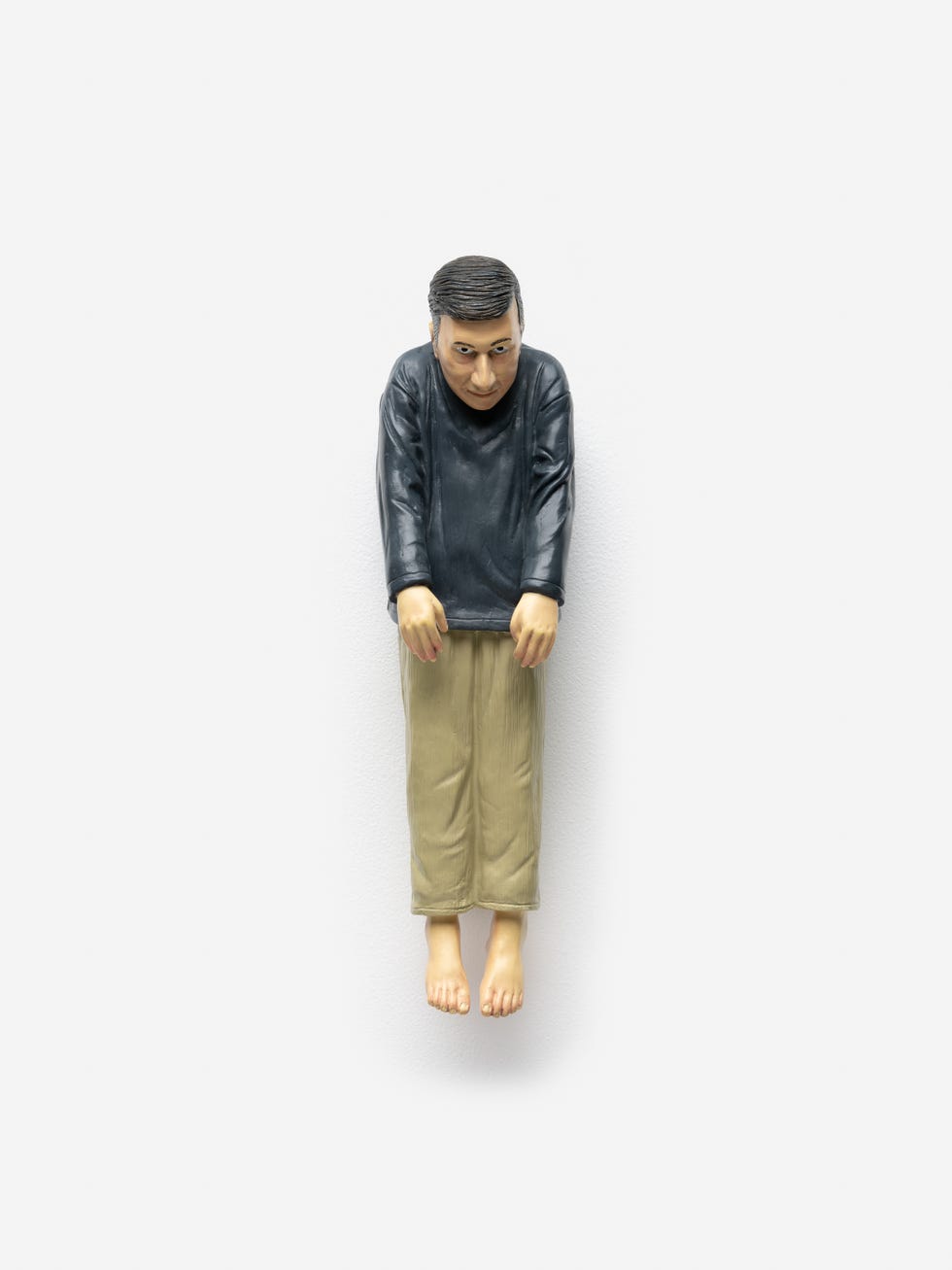 hanging figure resembling a human form in casual clothing